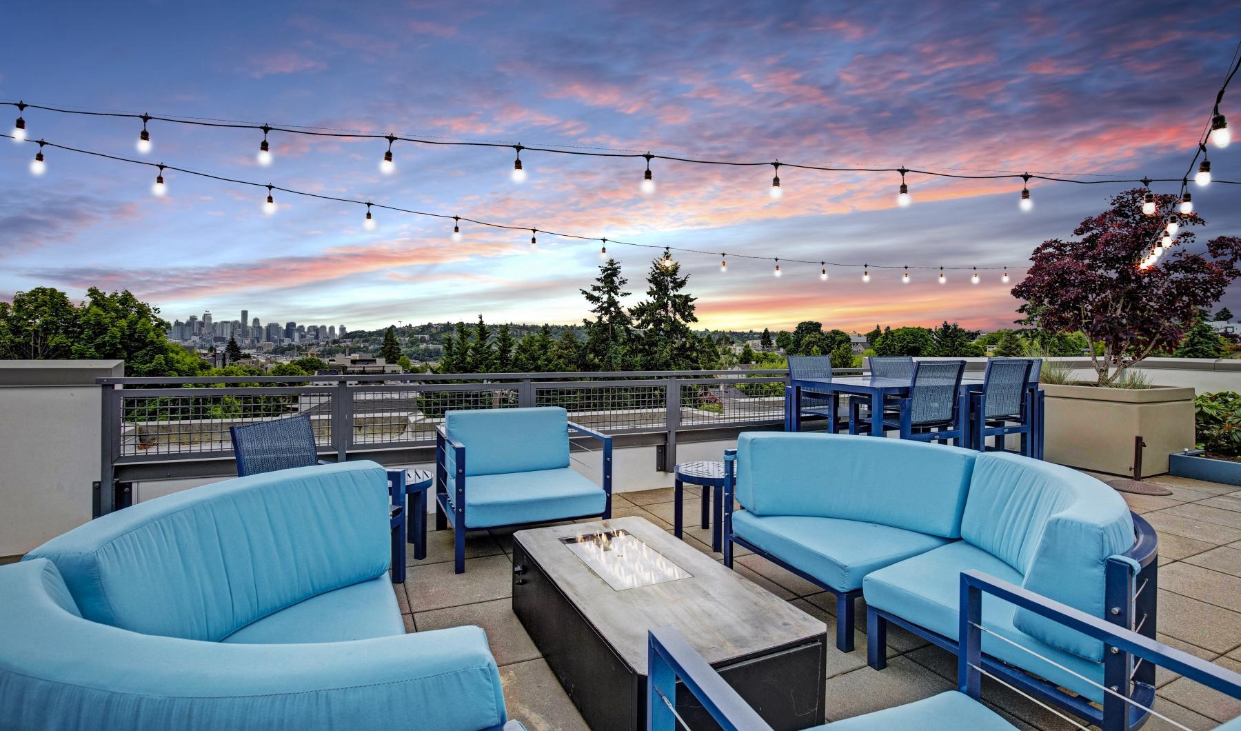 a group of blue chairs and a sunset