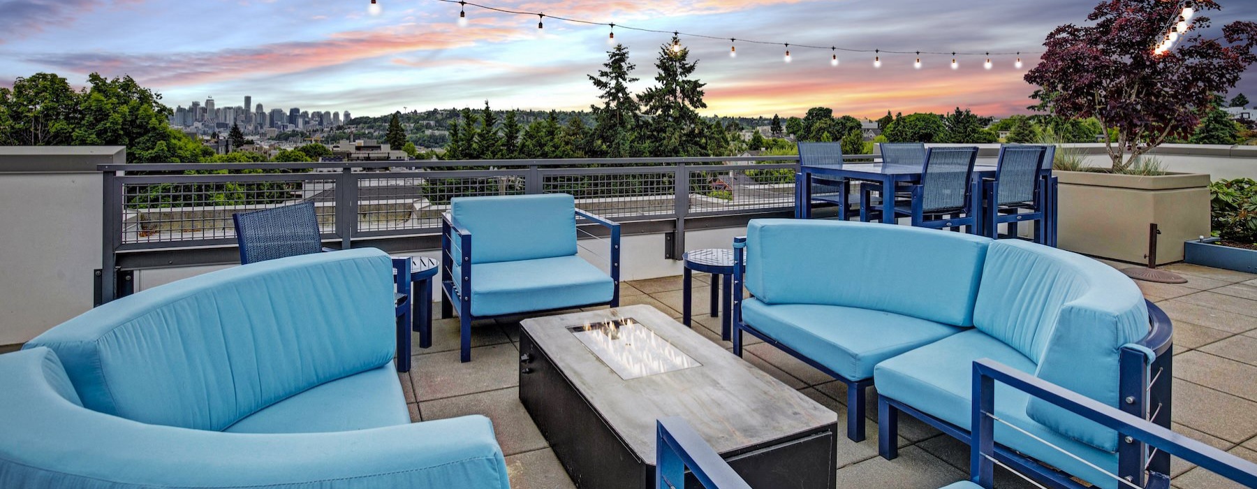 a group of blue chairs and a sunset