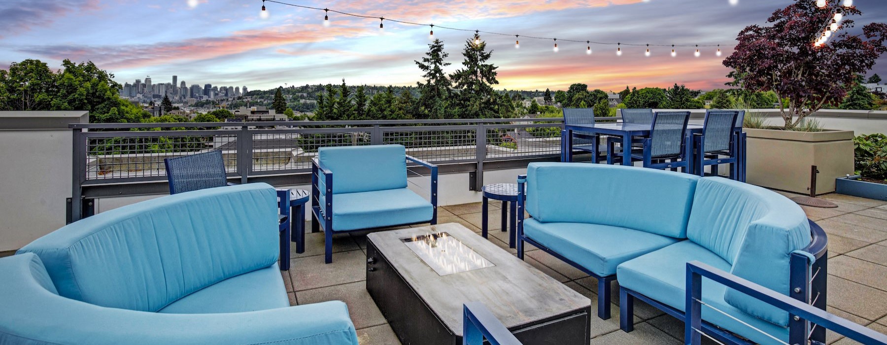 a group of blue chairs and a sunset